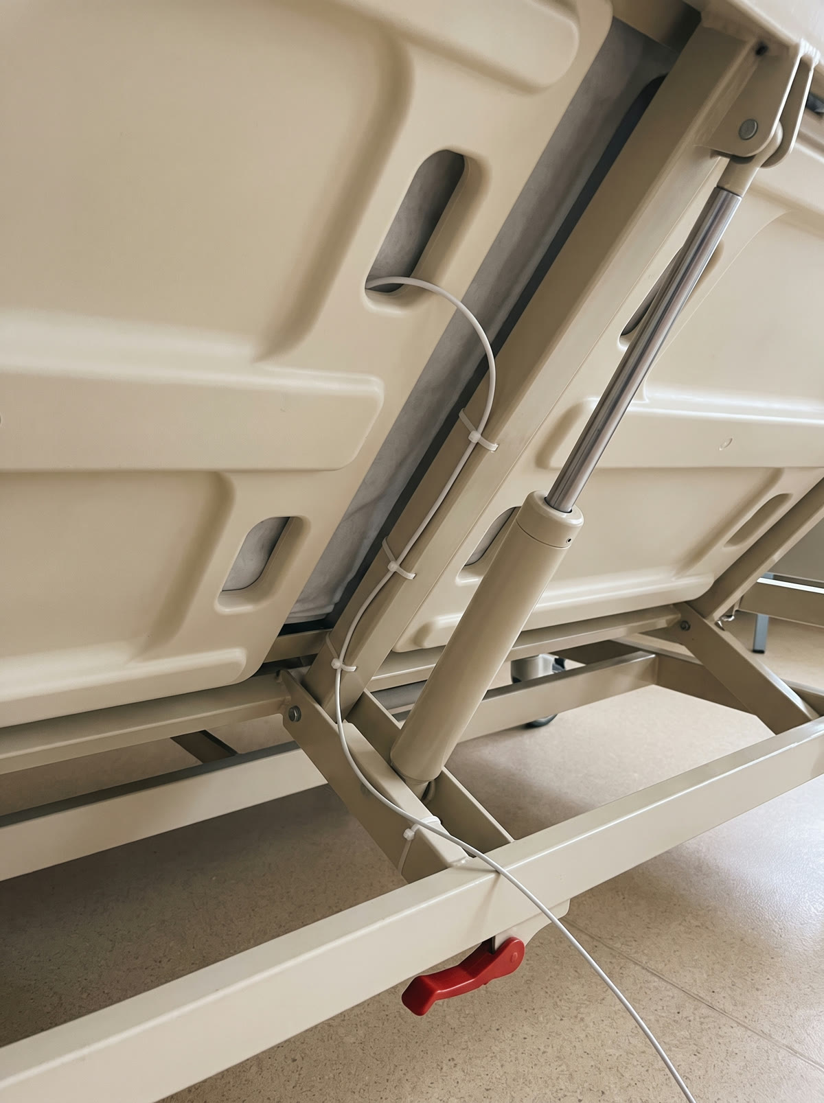 The cable tied along the bed frame under the deck